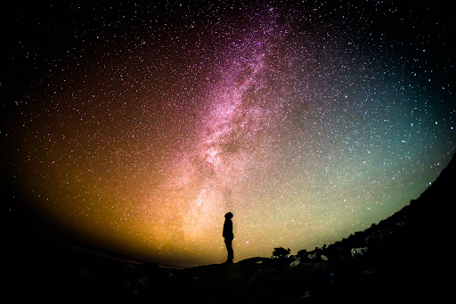 The silhouette of a man standing against the horizon