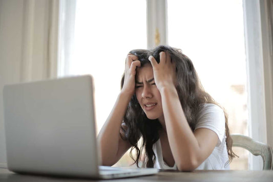 Woman trying to work but frustrated and can’t focus.