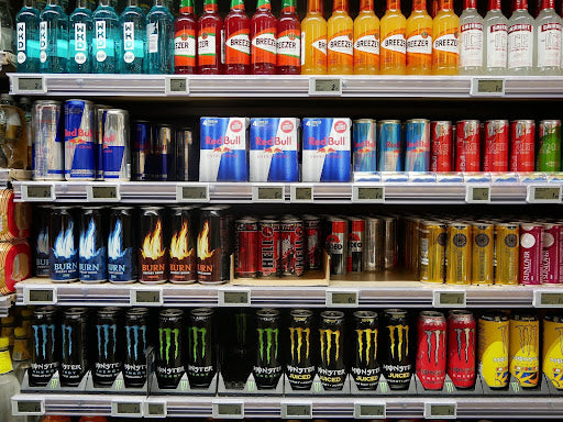 A shelf at a grocery store with energy drinks