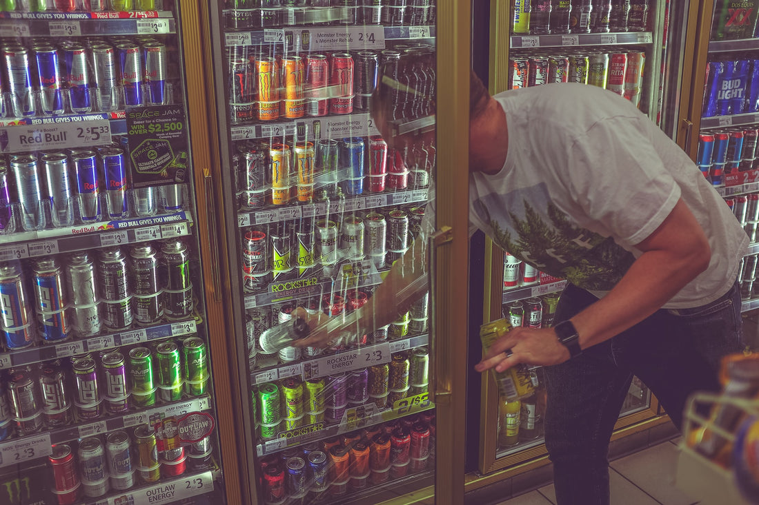 A man buying energy drinks at a convenience store